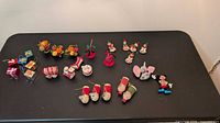 Entire assortment of 19 vintage Christmas ornaments laid out on table