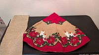 Folded burlap tree skirt with red border and separate burlap strip