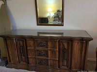 front view of wood buffet sideboard with glass top, showing overall design and finish