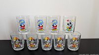 Full set of nine Millennium Celebration glasses showing three design groups