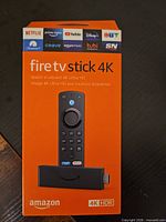 Front view of sealed Amazon Fire TV Stick 4K box showing device and remote