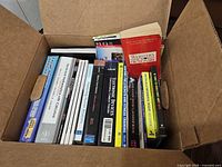 Box containing assorted textbooks and reference books, spine view