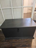Closed black painted blanket chest front view