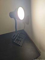 Lamp powered on showing illumination and organizer base compartments