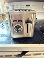 Front view showing Cuisinart logo, control dial, bagel and cancel buttons
