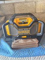 Front view of DeWalt DCR025 showing controls, display, speakers and branding