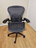 Front view of Herman Miller Aeron chair showing mesh seat, back and armrests