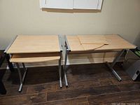 Two rectangular desk sections side by side with keyboard shelf visible