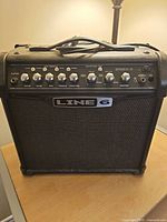 Front view of Line 6 Spider IV 15 combo amplifier showing grille, logo, and control knobs