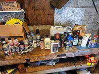 Workbench view showing full assortment of aerosols, motor oil jugs and additive bottles