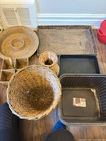 Overview showing wicker and plastic baskets and trays on floor
