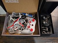 Snap quadcopter, controller, accessories grouped in box