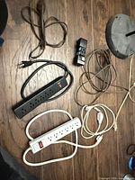 All cords, power strips and adapter laid out on floor