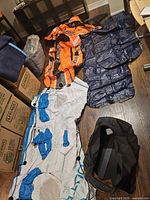 Lot overview showing orange Kondop rafts, blue mattresses, white Outbound tube and black carry bag