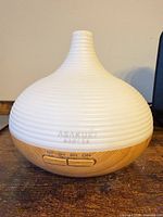 Front view of diffuser showing controls and wood-grain base