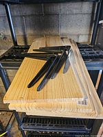 Stack of pine boards with black steel brackets on top