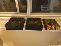 All three ashtrays on windowsill