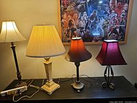 All four table lamps on console table