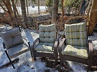 Front view showing three patio chairs with cushions