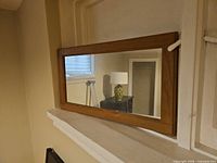 Front view of rectangular mirror with wood frame