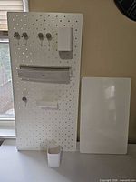 pegboard with attached accessories and separate dry-erase board