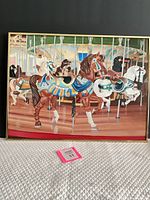 Full view of framed carousel painting showing composition and frame