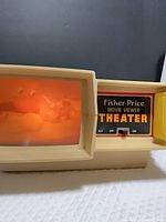 Front view of Fisher-Price Movie Viewer Theater showing lit screen and control panel