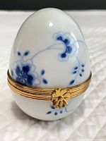 Front view showing blue floral design and gold band with clasp