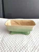 Planter angled view showing exterior glaze and footed base