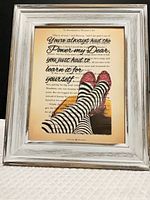 Front view of framed print showing quote, illustration, and frame