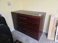 Front view of dark brown four-drawer dresser