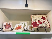 Overall lot showing plate, three plaques, fused glass piece and stands