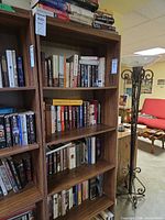 Two tall bookshelves filled with assorted fiction and mystery books