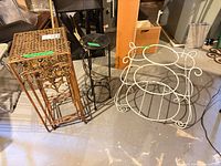 Three metal plant stands side by side on floor