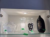 All four glass and crystal pieces on shelf