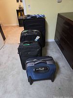 Four suitcases lined up by size