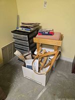 Overall lot showing storage organizer, books, kits box, wooden stool