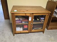 Front view showing two glass doors, knob, interior shelf and overall wear