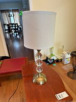 Full view of lamp with shade, base, and cord visible