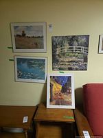 Four reproduction prints displayed against wall