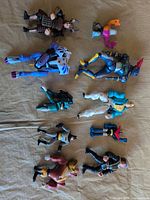 Overview of all ten figures laid out on cloth background