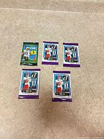 All five sealed card packs laid out