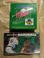 Front view of both board game boxes