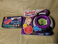 Twister Dance Rave game and Stacking Blocks toy boxes side by side