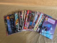 Stack of 30 assorted independent comic books spread out to show covers and spines