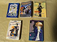 Overview of four manga books and Fruits Basket card game box