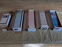 Five storage boxes of baseball cards lined up