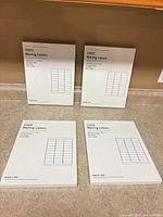 Four Baseline mailing label packs front view