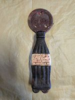 Full view of cast iron Coca-Cola bottle door handle
