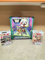 Front view of all three boxed items: two Pop figures and ring playset